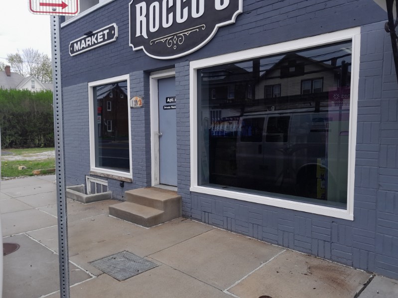 Completed commercial storefront windows and entry door on a brick building